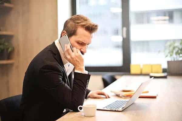 businessman on phone chasing money