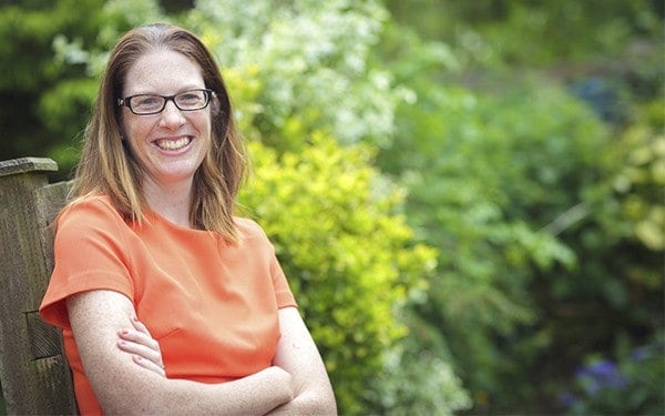 Freelance PR professional Andrea Sexton sat on a bench in her garden.