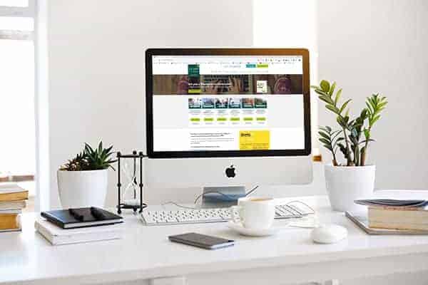 White freelancer desk and iMac in home office