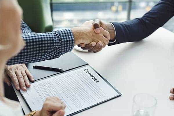 IR35 existing contracts - contractor and company manager shaking hands over contract