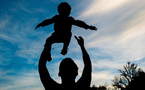 Dad holding son in the air