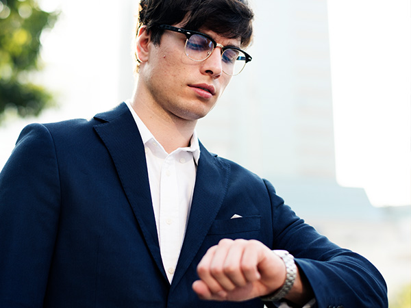 Businessman in suit looking at his watch