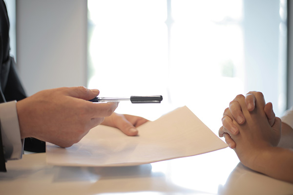 Freelancer agreeing and signing business loan during bank meeting