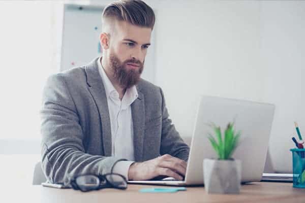 Freelancer working on laptop in home office