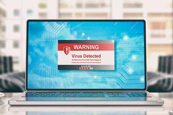 Cyber liability insurance from Caunce OHara - Laptop displaying virus warning sign.