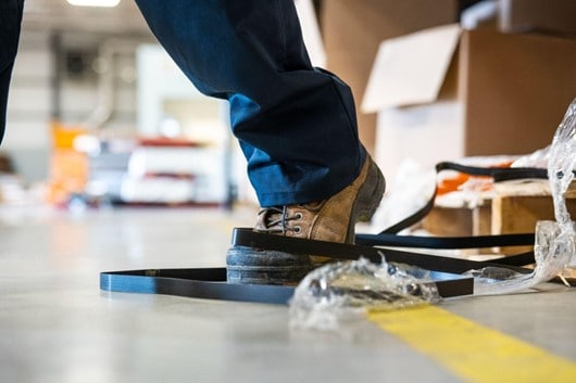 A person about to trip over a cable tie at work