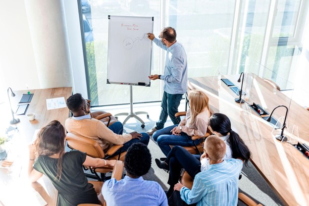 A trainer giving a flip chart presentation to employees