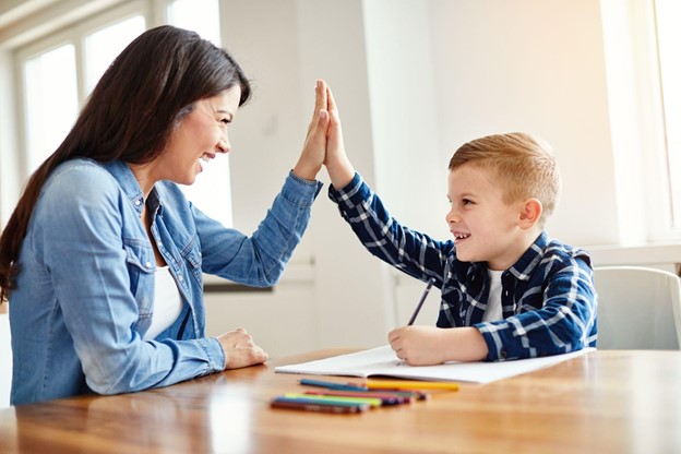 A tutor giving a student a high-five.