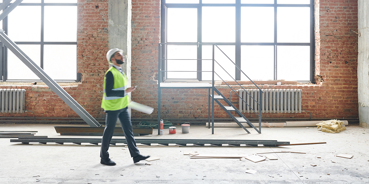 Builder surveying the inside of a building site